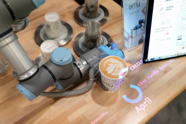 The Artly barista robot serves a drink during the CES tech show Wednesday, Jan. 10, 2024, in La ...