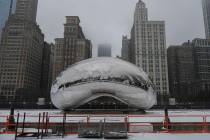 Snow covers the Cloud Gate sculpture in Millennium Park after a winter storm, Friday, Jan. 12, ...