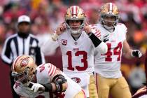 San Francisco 49ers quarterback Brock Purdy (13) signals to his team as they line up during the ...