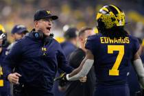 Michigan running back Donovan Edwards celebrates after scoring with head coach Jim Harbaugh dur ...