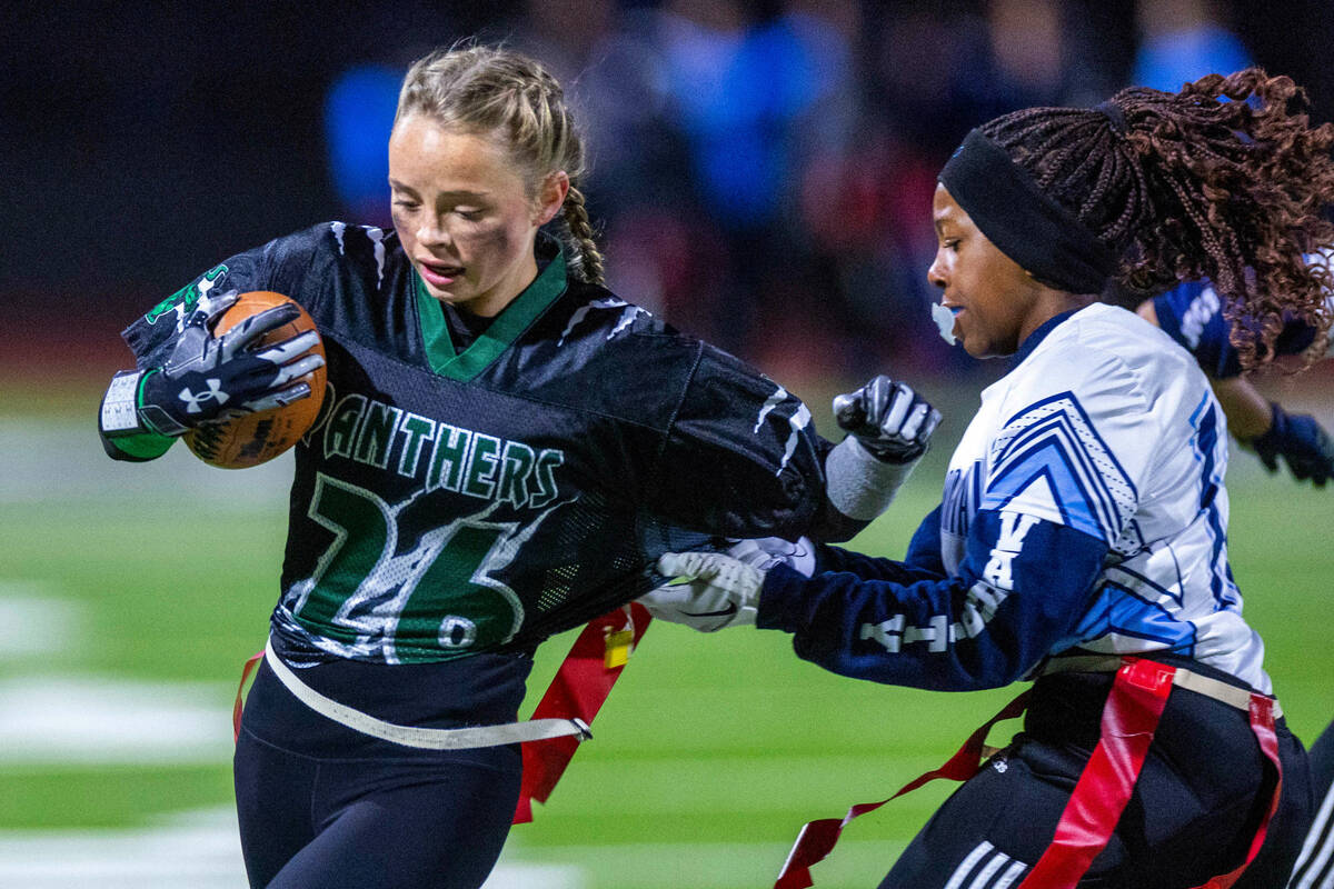 Palo Verde runner Samantha Manzo (26) has her flag pulled by Centennial defender Carissa McWill ...