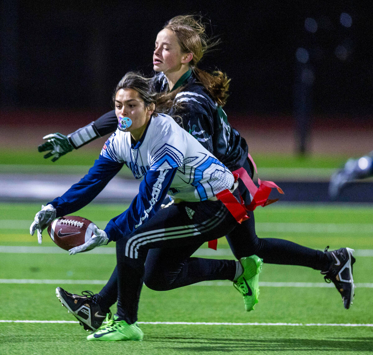 Centennial receiver Kaylynn DeFeo (4) attempts a catch with Palo Verde defender Alexis Manzo (1 ...