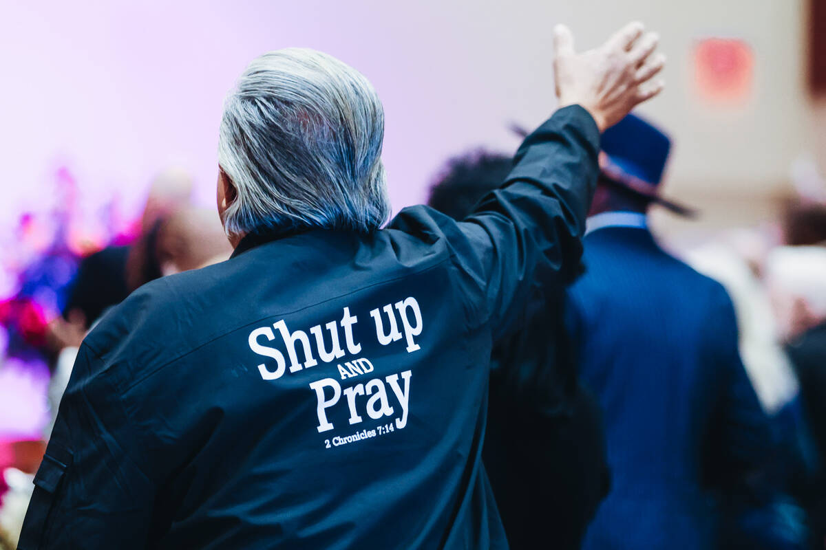 A worshipper puts their hand up during a sermon at the Citywide Unity Prayer Celebration at the ...