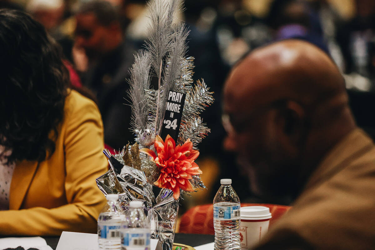 A table piece with the phrase “pray more in ’24” sits at a table during th ...