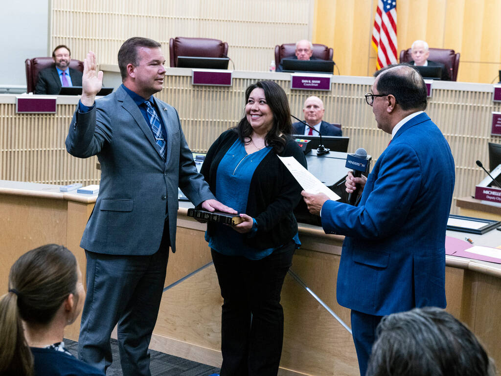 Jim Seebock, left, is sworn in as a member of the Henderson City Council by City Clerk Jose Lui ...