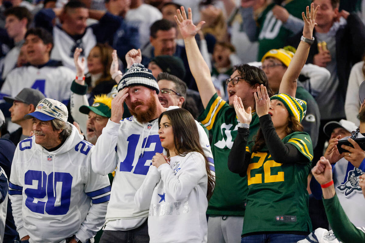 Spectators react to a miss field goal attempt by the Dallas Cowboys during the second half of a ...