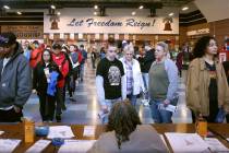Democratic caucusgoers sign in at the caucus site at Liberty High School on Feb. 22, 2020, in H ...