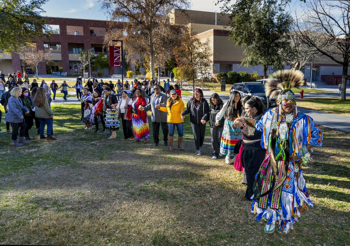 Navajo dancer Keanu Bedonie leads attendees holding hands on a round dance about the amphitheat ...