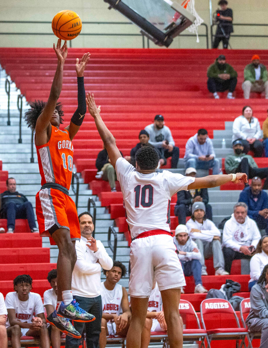 Bishop Gorman guard Nick Jefferson (10) gets off a shot over Arbor View guard Trammell Darden, ...