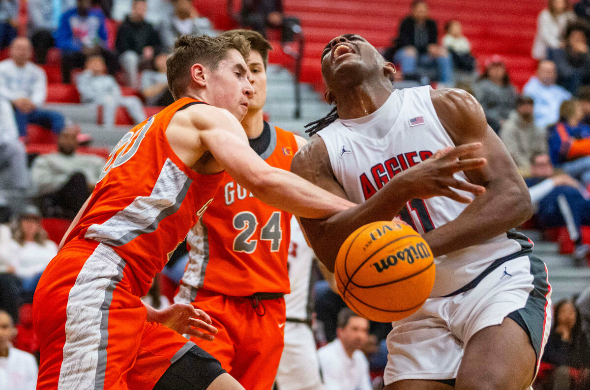 Arbor View forward Brian “Chef” Townsend (11) is fouled hard by Bishop Gorman gua ...