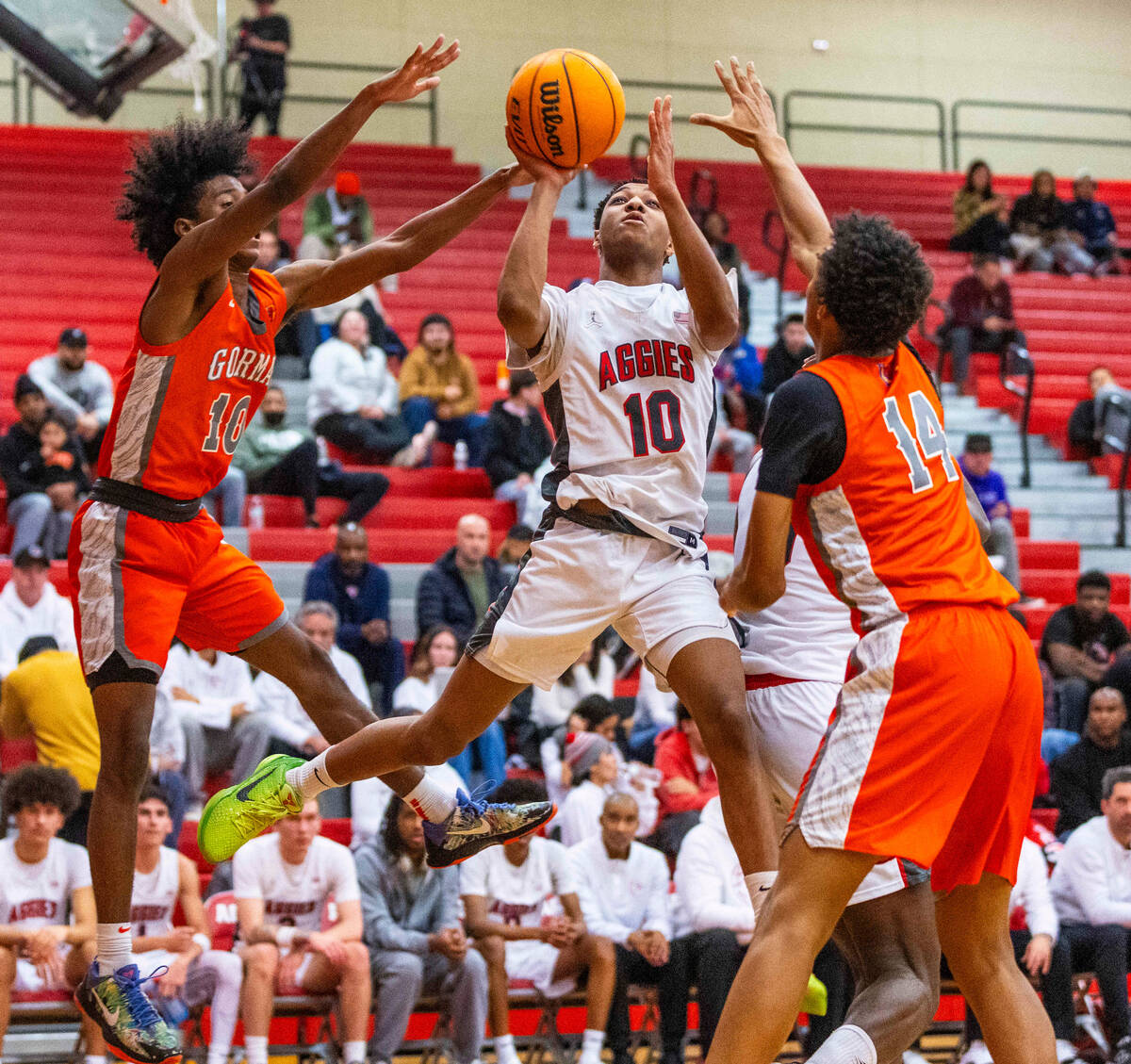 Arbor View guard Trammell Darden, Jr. (10) splits Bishop Gorman guard Nick Jefferson (10) and g ...