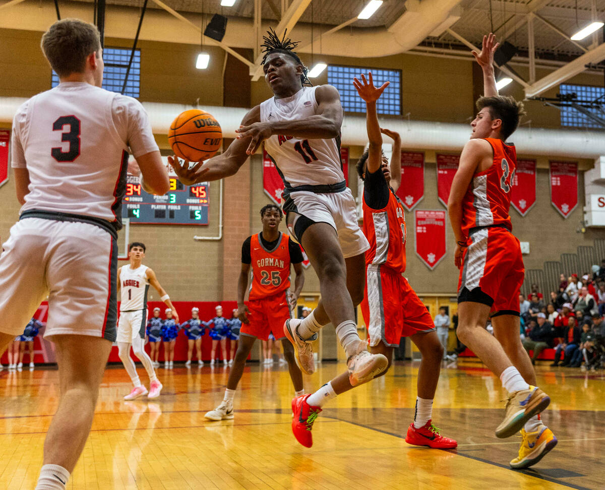 Arbor View forward Brian “Chef” Townsend (11) gets inside Bishop Gorman guard Kam ...