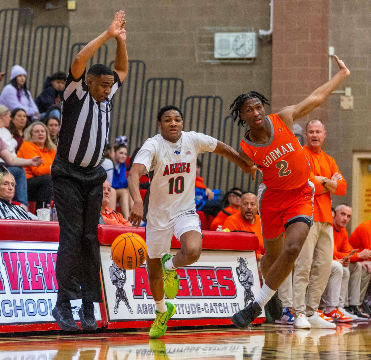 Arbor View guard Trammell Darden, Jr. (10) is fouled on a drive by Bishop Gorman forward Jett W ...