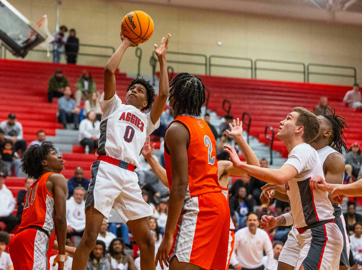 Arbor View guard DeMarion Yap (0) elevates for a basket as Bishop Gorman forward Jett Washingto ...