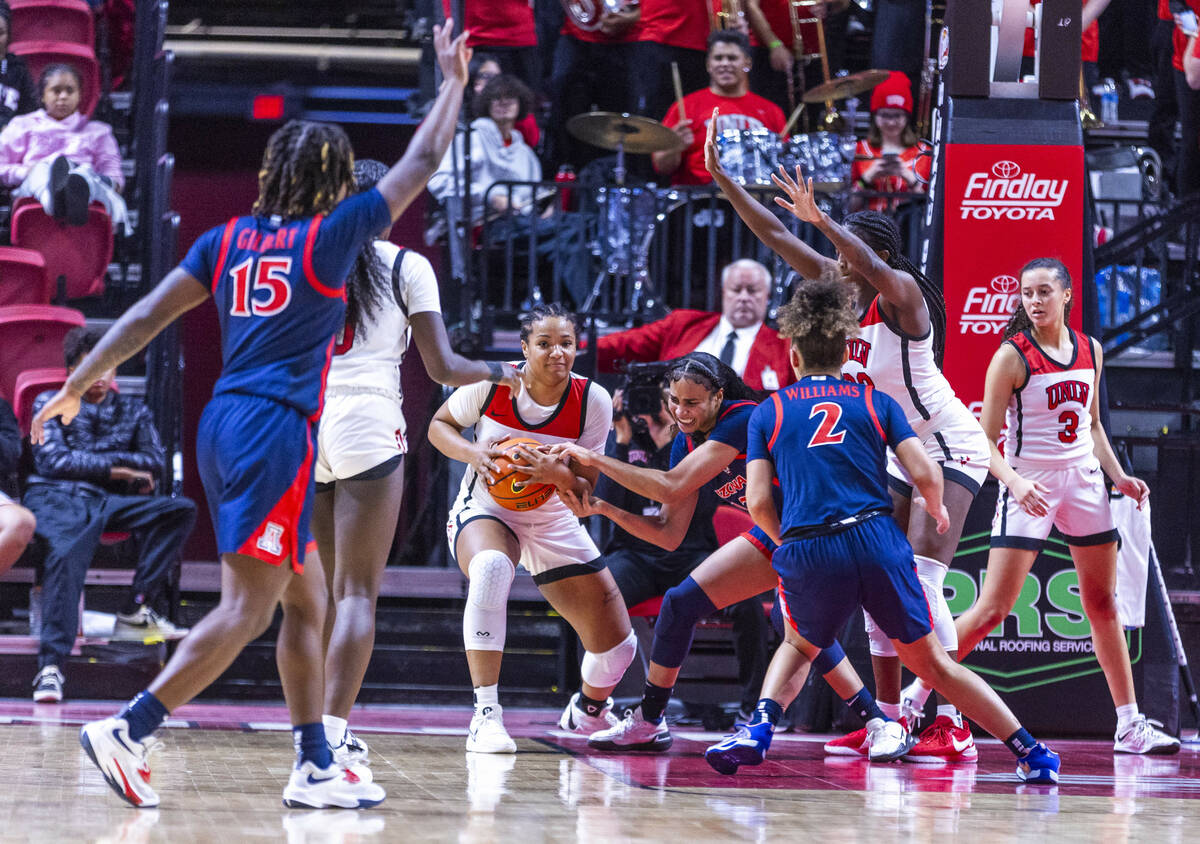 UNLV Lady Rebels forward Alyssa Brown (44) takes the ball away from Arizona Wildcats forward Es ...