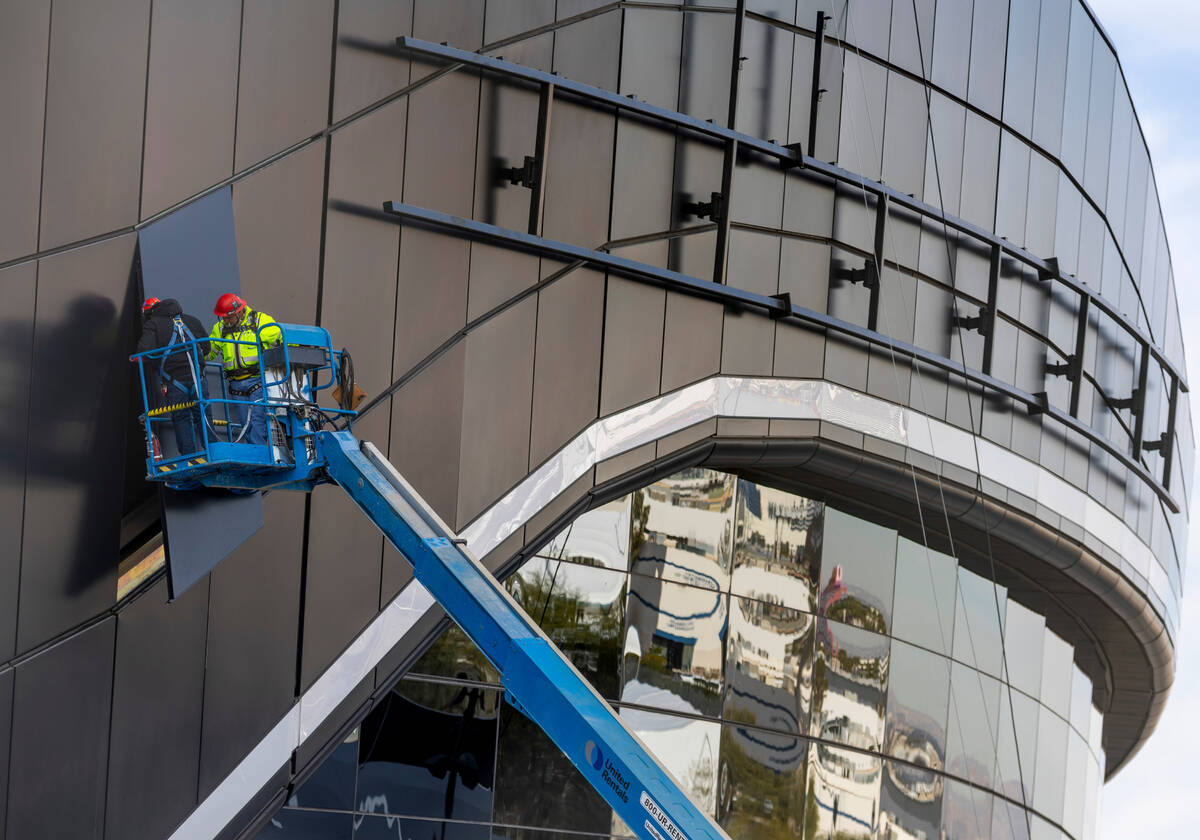 A crew works on exterior panels as Super Bowl preparations continue at Allegiant Stadium on Wed ...