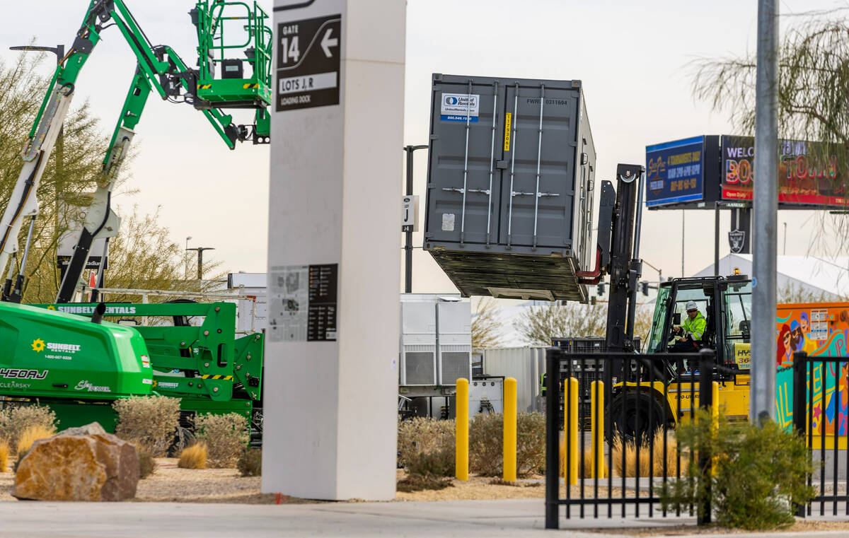 Containers are moved into place in a parking lot as Super Bowl preparations continue at Allegia ...