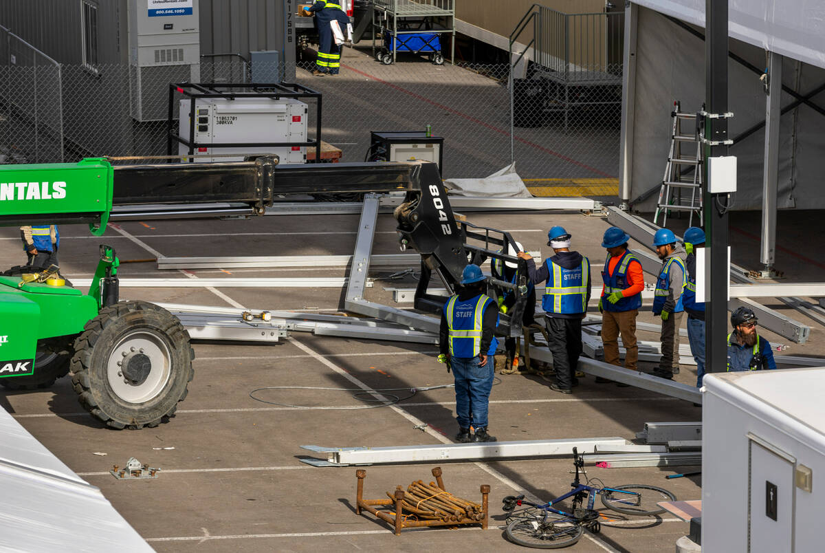 A crew assemblies another tent in a parking lot as Super Bowl preparations continue at Allegian ...