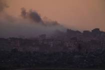 Smoke rises after an explosion in the Gaza Strip as seen from southern Israel, Tuesday, Jan. 16 ...