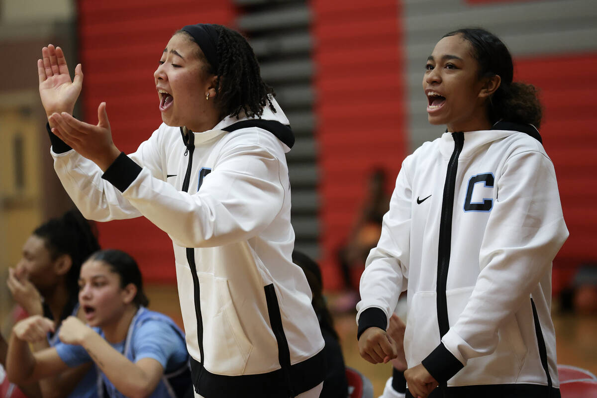 Centennial’s bench cheers for their team during the second half of a high school basketb ...