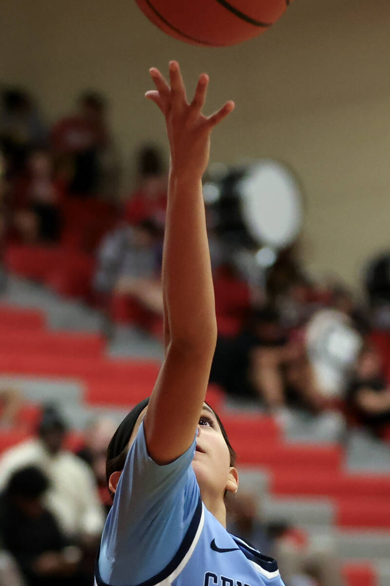 Centennial's Bella Crawford (00) hands in a layup during the second half of a high school baske ...