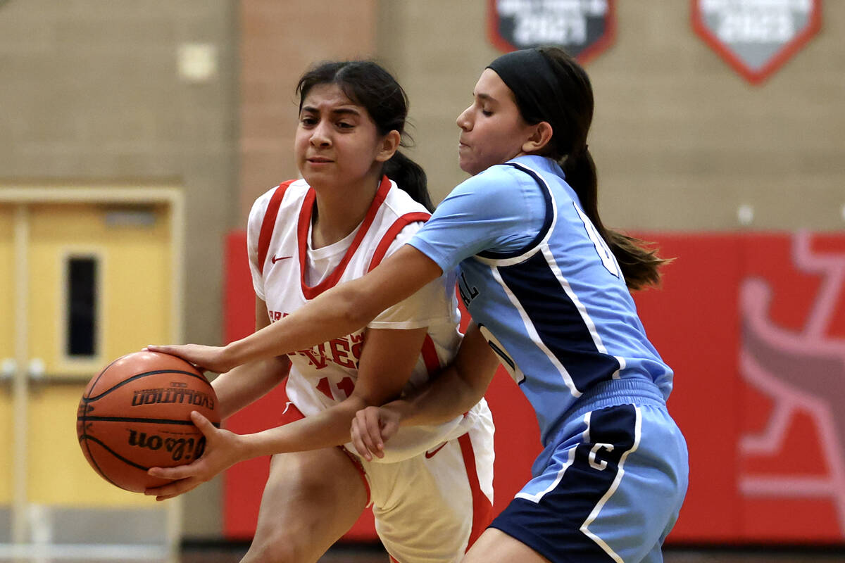 Arbor View's Arianna Vera (11) drives toward the hoop while Centennial's Bella Crawford (00) ge ...