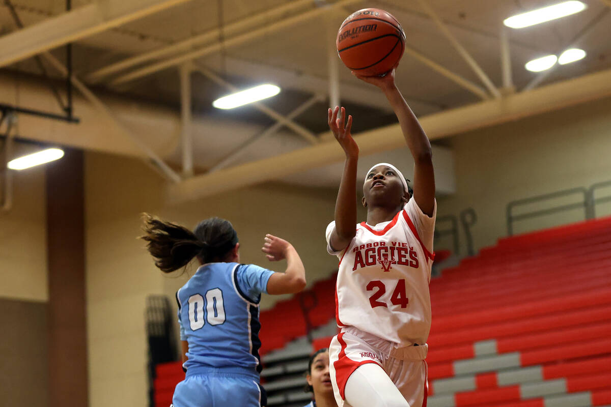 Arbor View's Sanai Branch (24) shoots against Centennial's Bella Crawford (00) during the first ...