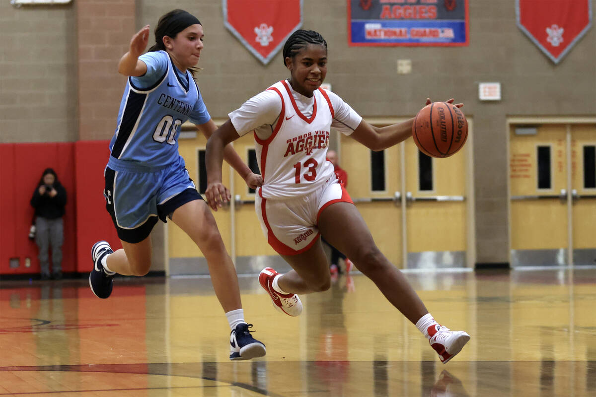 Arbor View's Talyiah Mckinney (13) dribbles against Centennial's Bella Crawford (00) during the ...