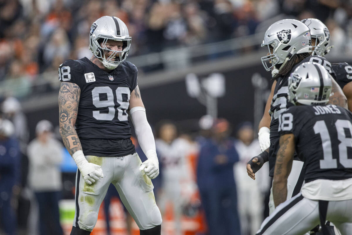 Raiders defensive end Maxx Crosby (98) celebrates a sack with teammates during the first half o ...