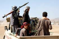 Houthi fighters and tribesmen stage a rally against the U.S. and the U.K. strikes on Houthi-run ...