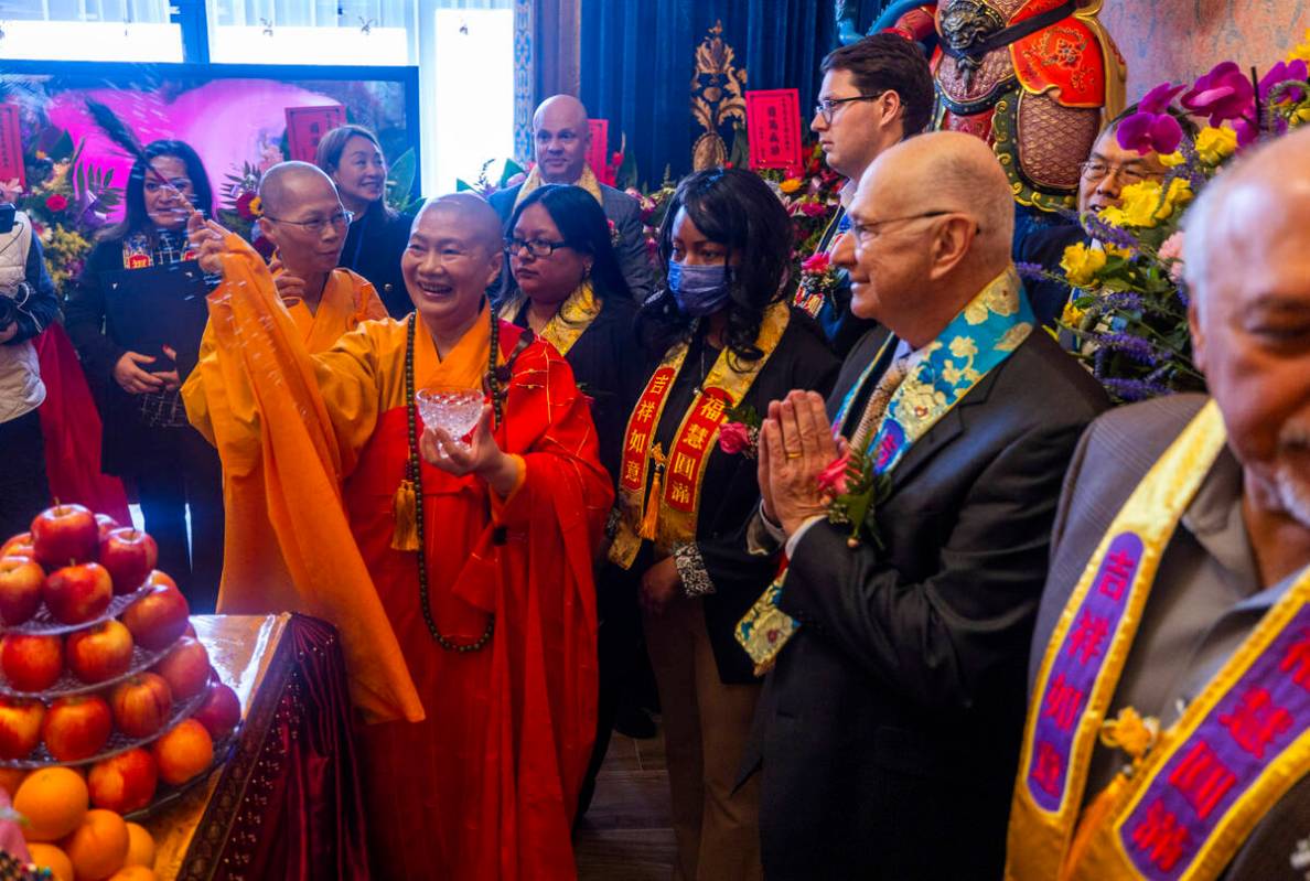 Holy Guru Zhengda Jiaozun sprinkles blessed water while joined by invited dignitaries about an ...