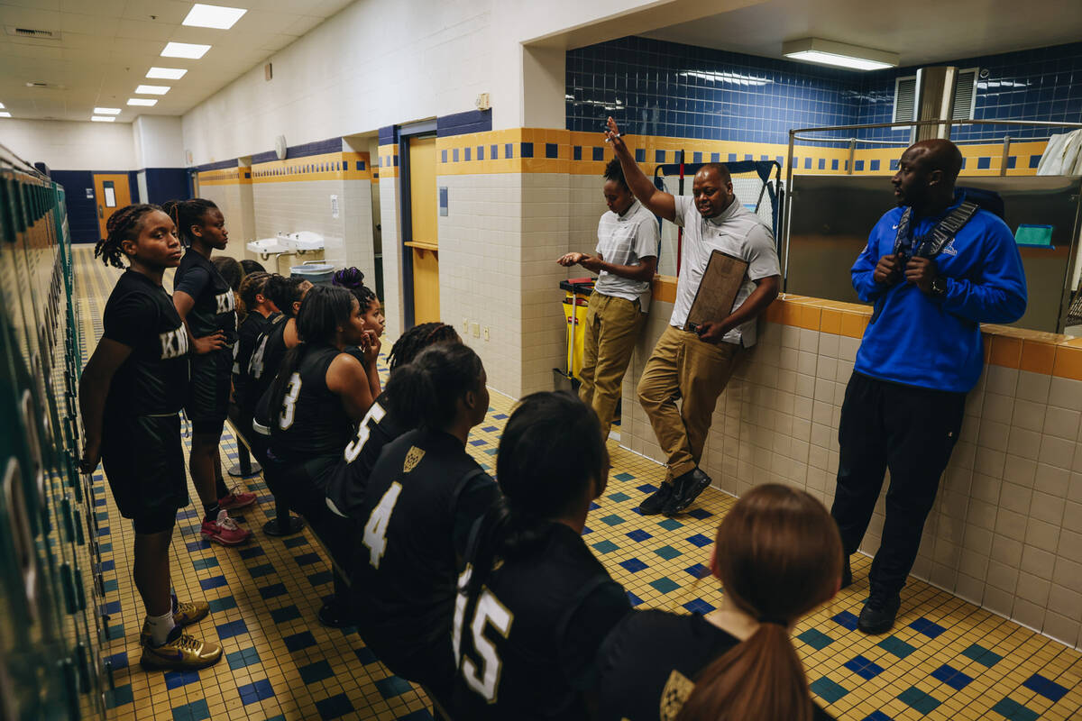 The Democracy Prep girls basketball team listen to speeches from their coaches in the locker ro ...