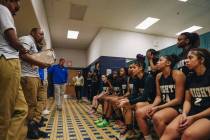 The Democracy Prep girls basketball team listen to speeches from their coaches in the locker r ...