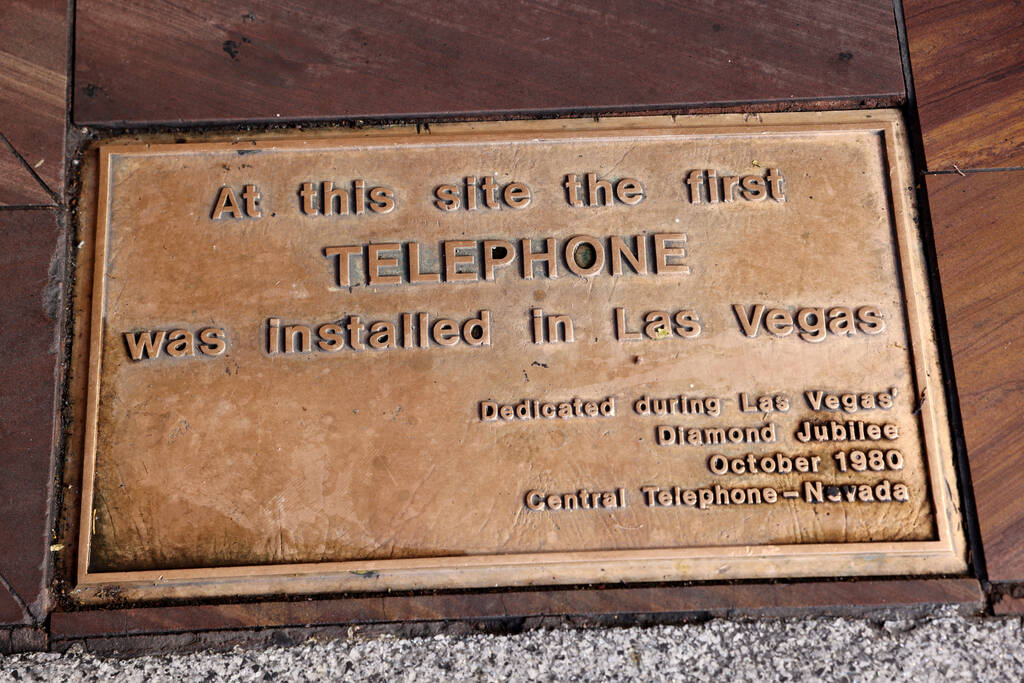 A plaque marking the site of the first phone in Las Vegas is shown outside the Golden Gate on t ...