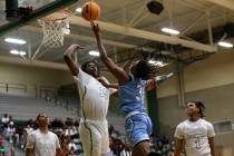 Rancho forward R’Zha Whittle prepares to block a shot by Canyon Springs guard Emanuel Cu ...