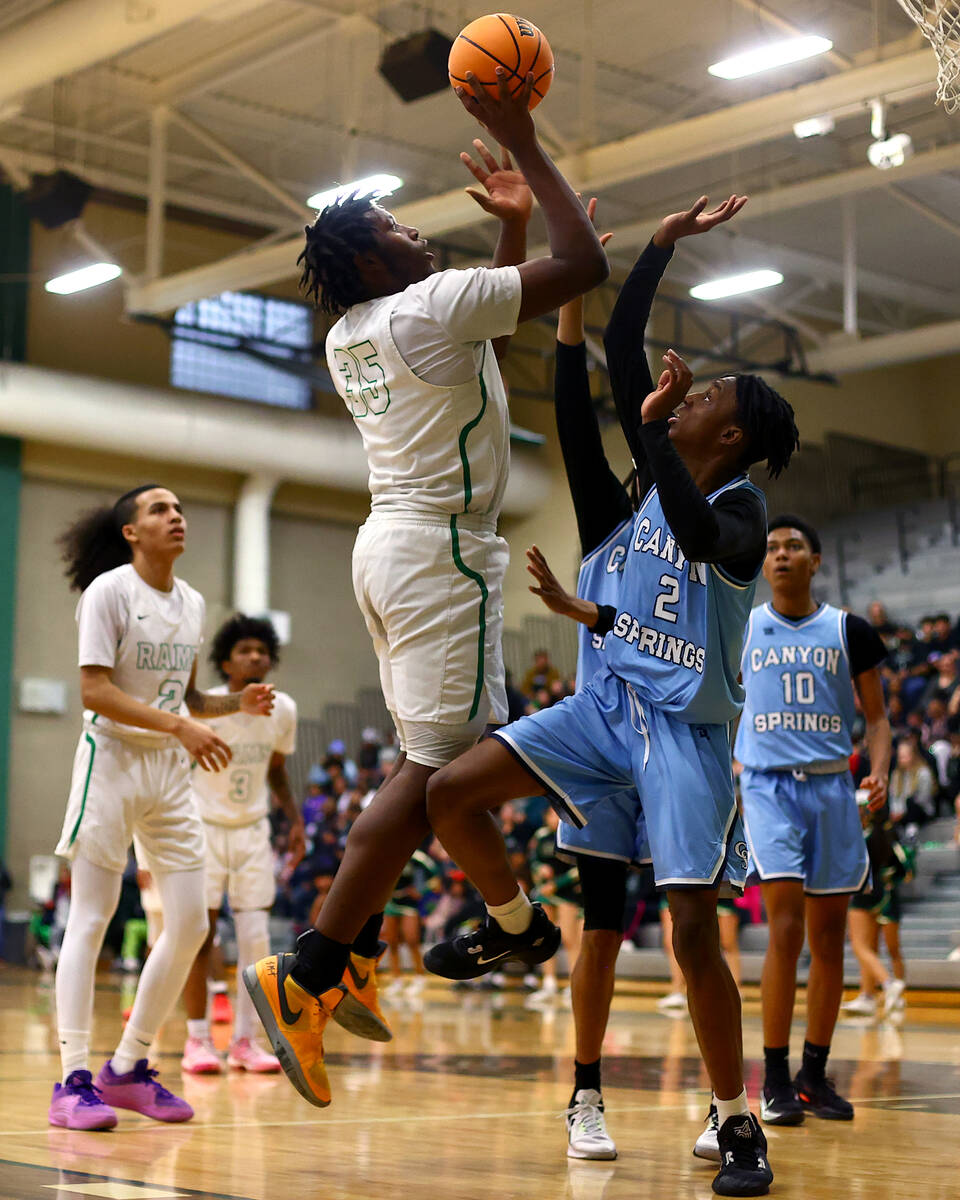 Rancho forward R’Zha Whittle (35) shoots against Canyon Springs guard Melvin Reece (2) d ...