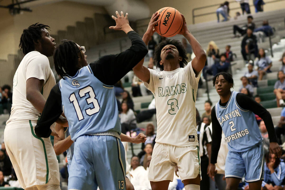 Rancho guard Jordan Childress (3) shoots against Canyon Springs guard Ma’Aqwavious Mackl ...