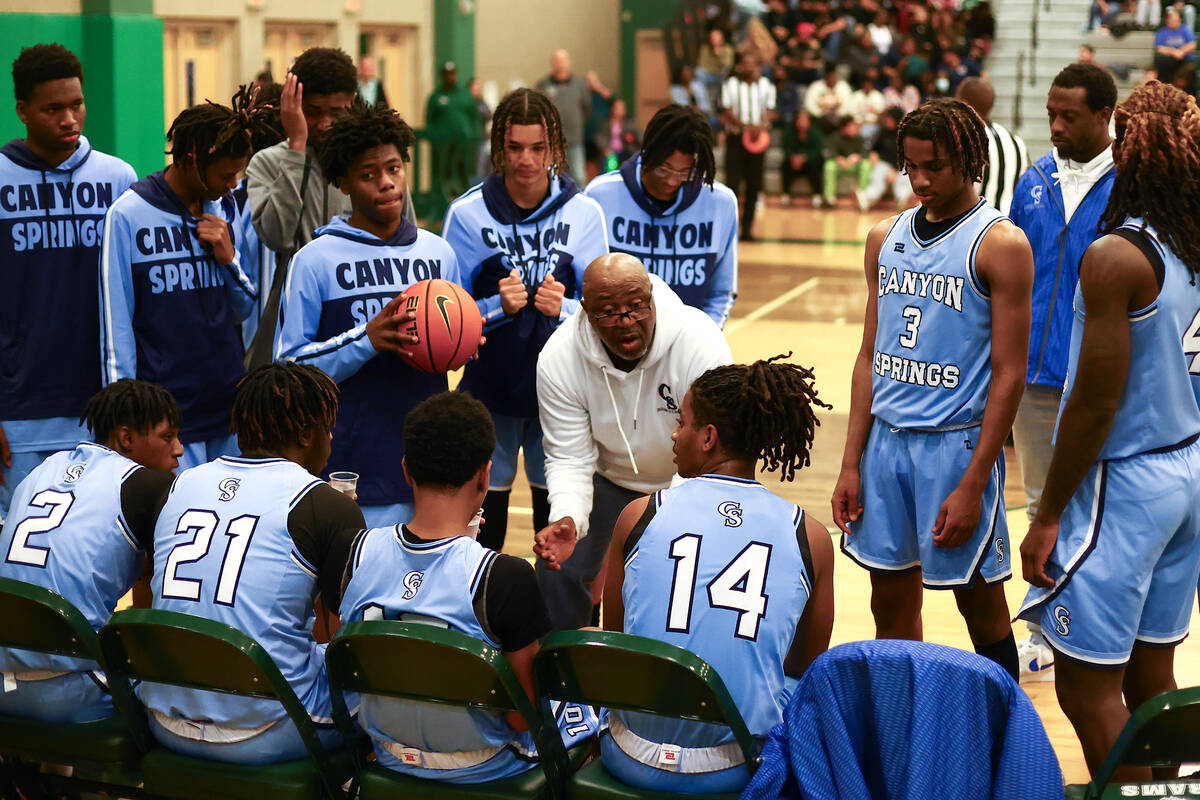 Canyon Springs head coach Freddie Banks speaks to his team during a timeout in the second half ...