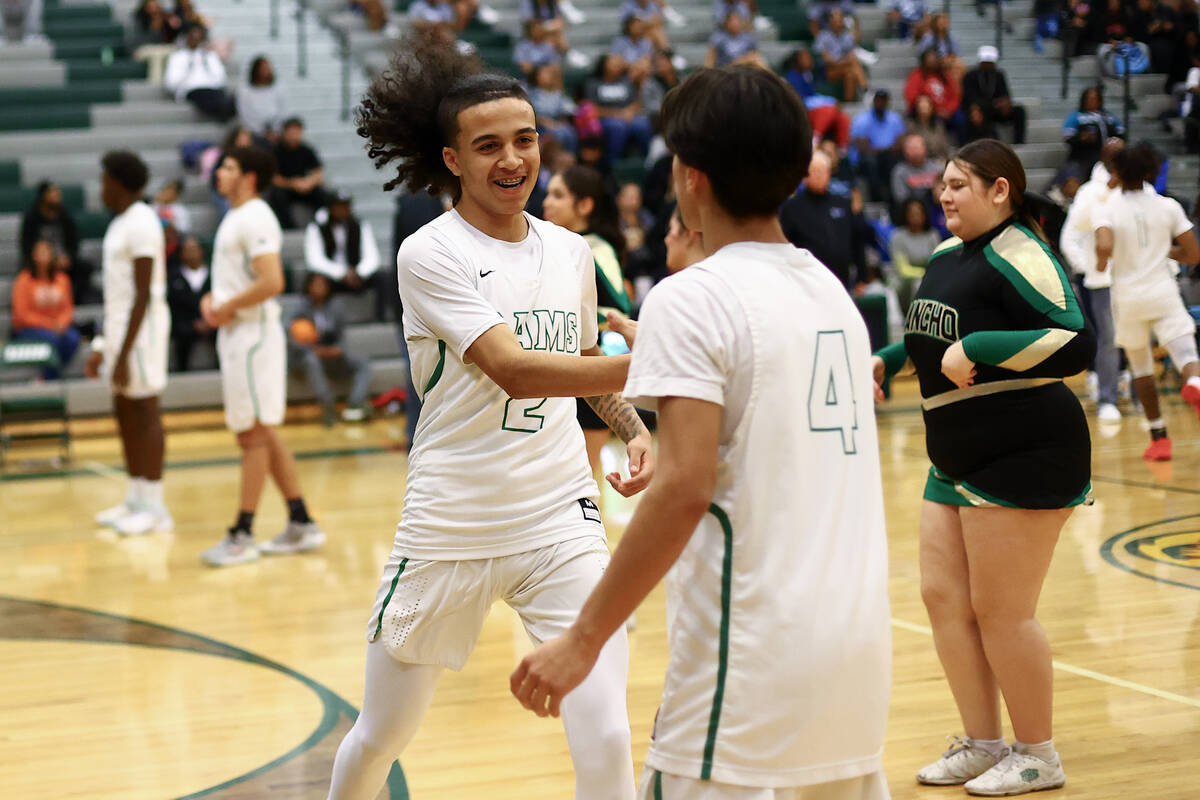 Rancho guard Jakoi Lide (2) slaps hands with guard Ricardo Rodriguez as he is announce in the s ...