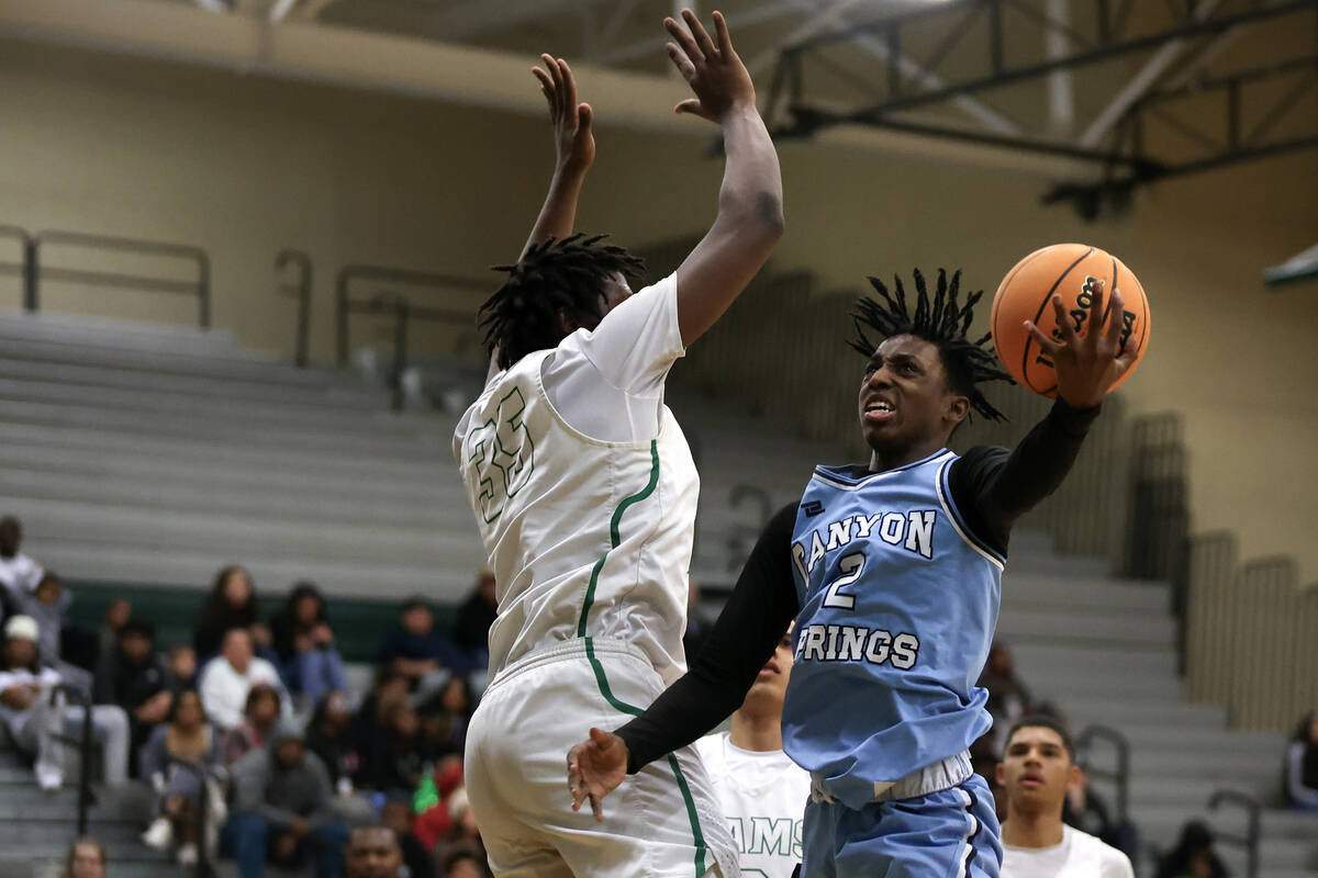 Canyon Springs guard Melvin Reece (2) shoots against Rancho forward R’Zha Whittle (35) d ...