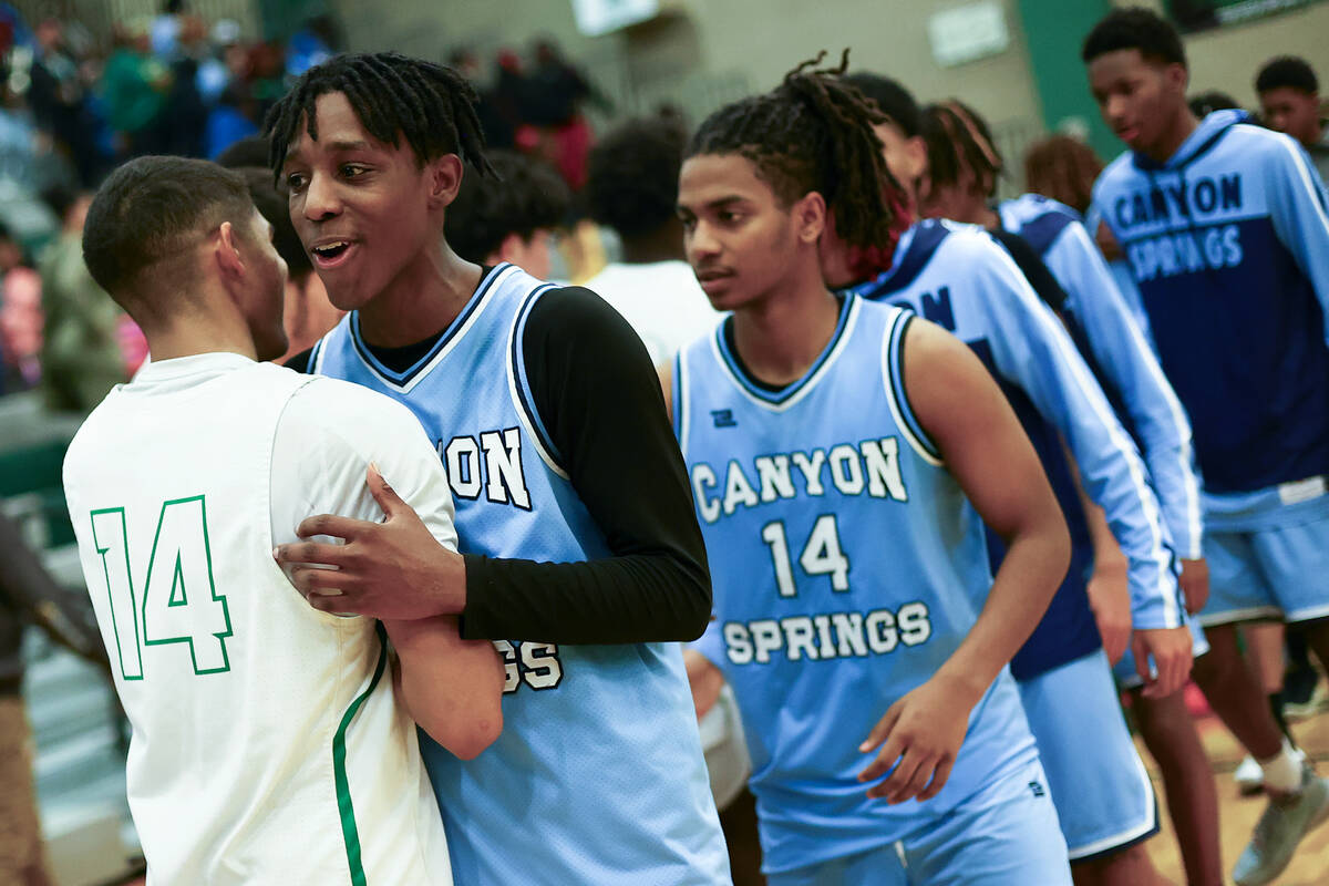 Canyon Springs guard Melvin Reece embraces Rancho guard Caleb Roston (14) after Rancho won thei ...