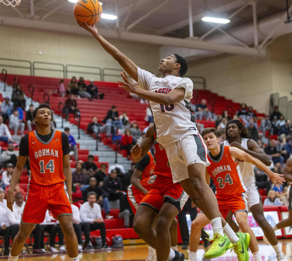 Arbor View guard Trammell Darden, Jr. (10) beats Bishop Gorman forward Jett Washington (2) to t ...