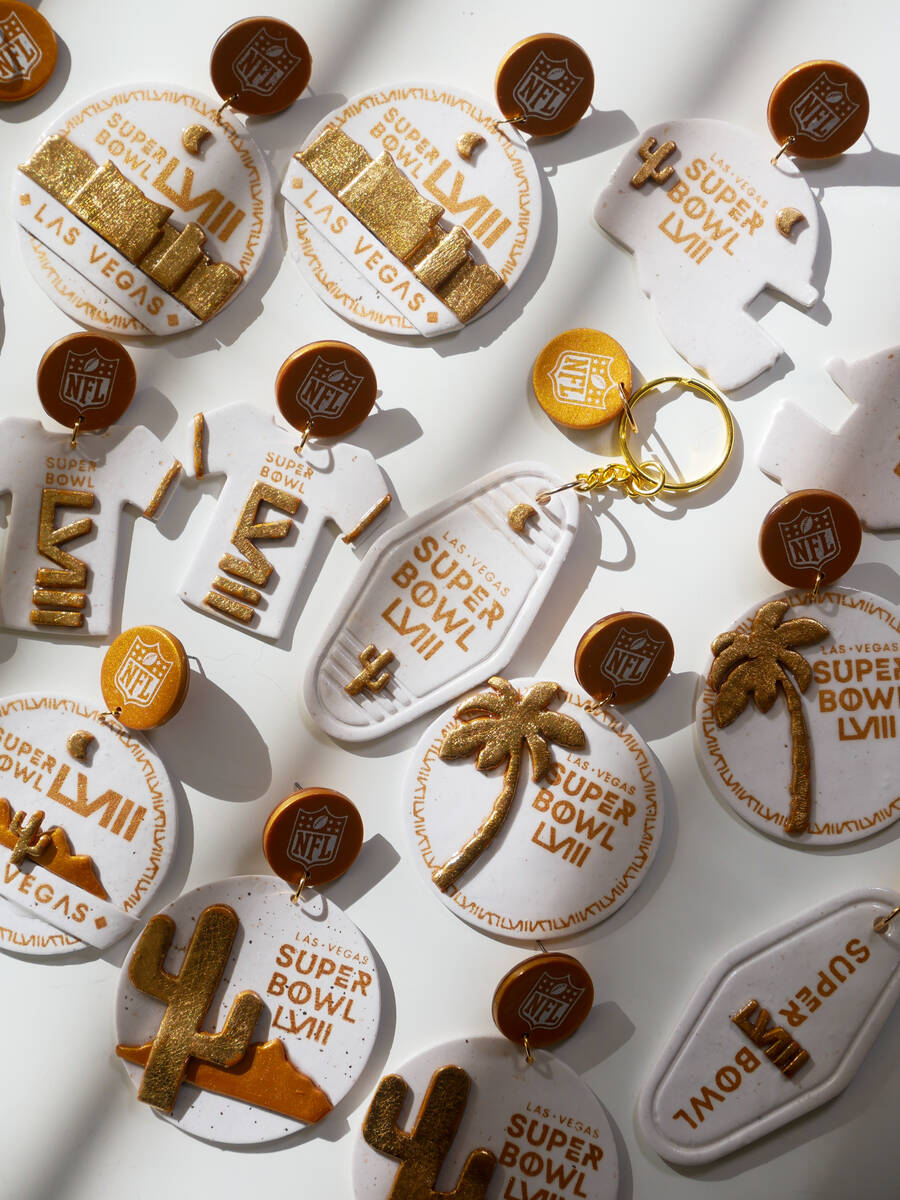 The glittering gold lineup of earrings and keychains designed by the Las Vegas based Love, Hand ...