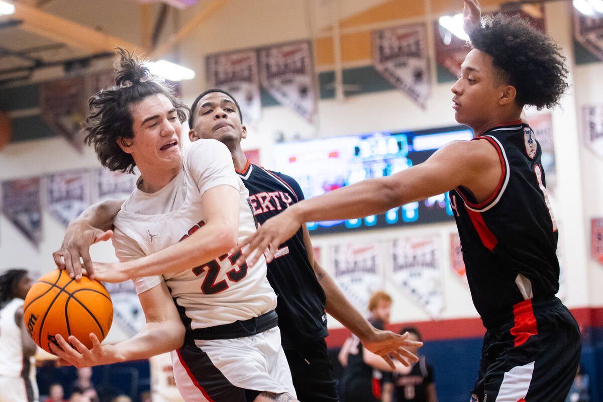 Arbor View’s Thaddeus Thatcher (23) looks to pass the ball around Liberty’s Yasir ...