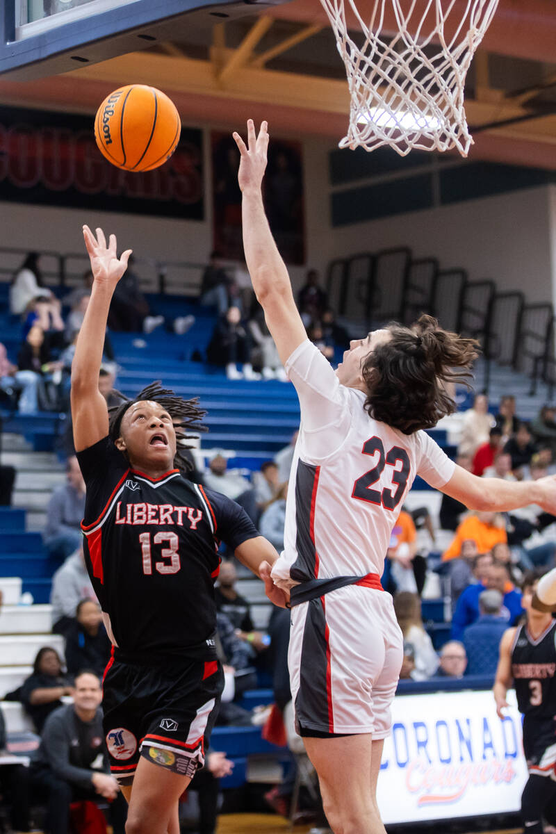 Liberty’s Jaden Riley (13) take a shot while Arbor View’s Thaddeus Thatcher (23) ...