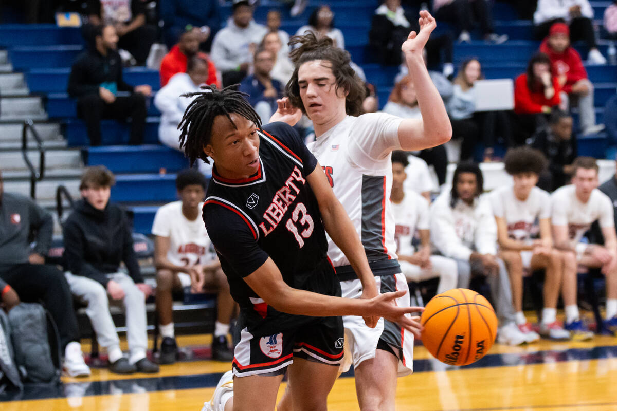 Liberty’s Jaden Riley (13) passes the ball around Arbor View’s Thaddeus Thatcher ...