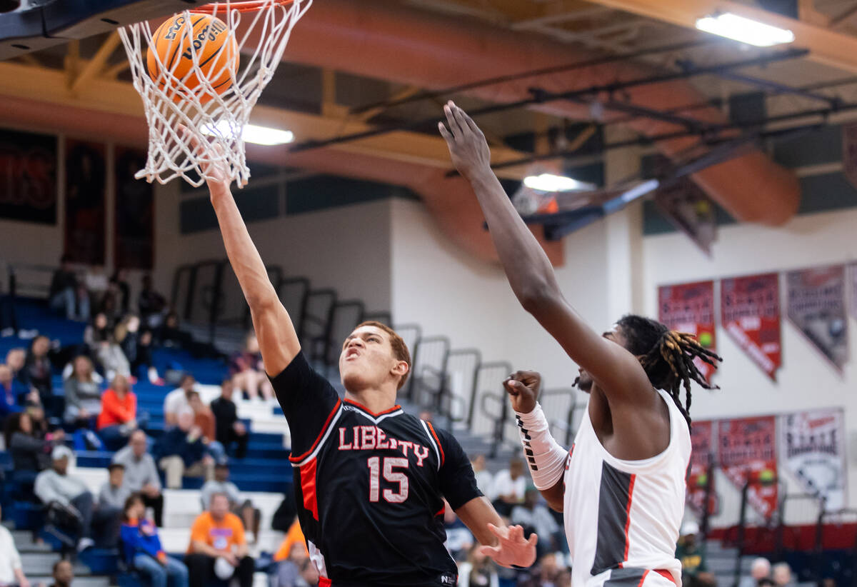 Liberty’s Dante Steward (15) shoots a layup while Arbor View’s Pharaoh Compton (1 ...