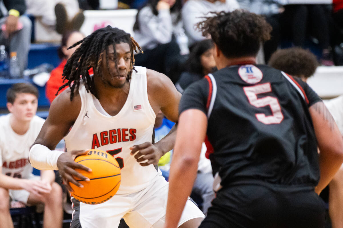 Arbor View’s Pharaoh Compton (5) looks where to move the ball during a basketball game b ...