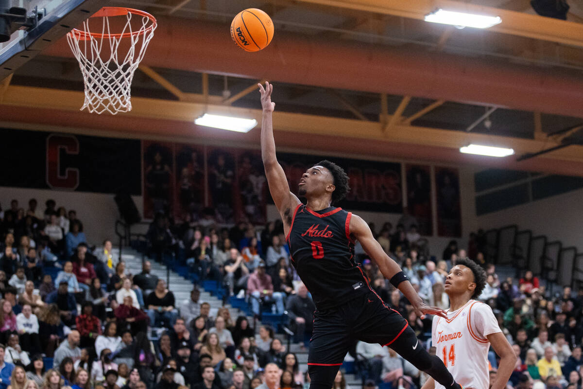 Coronado’s Jonny Collins (0) takes a shot during a basketball game between Coronado and ...