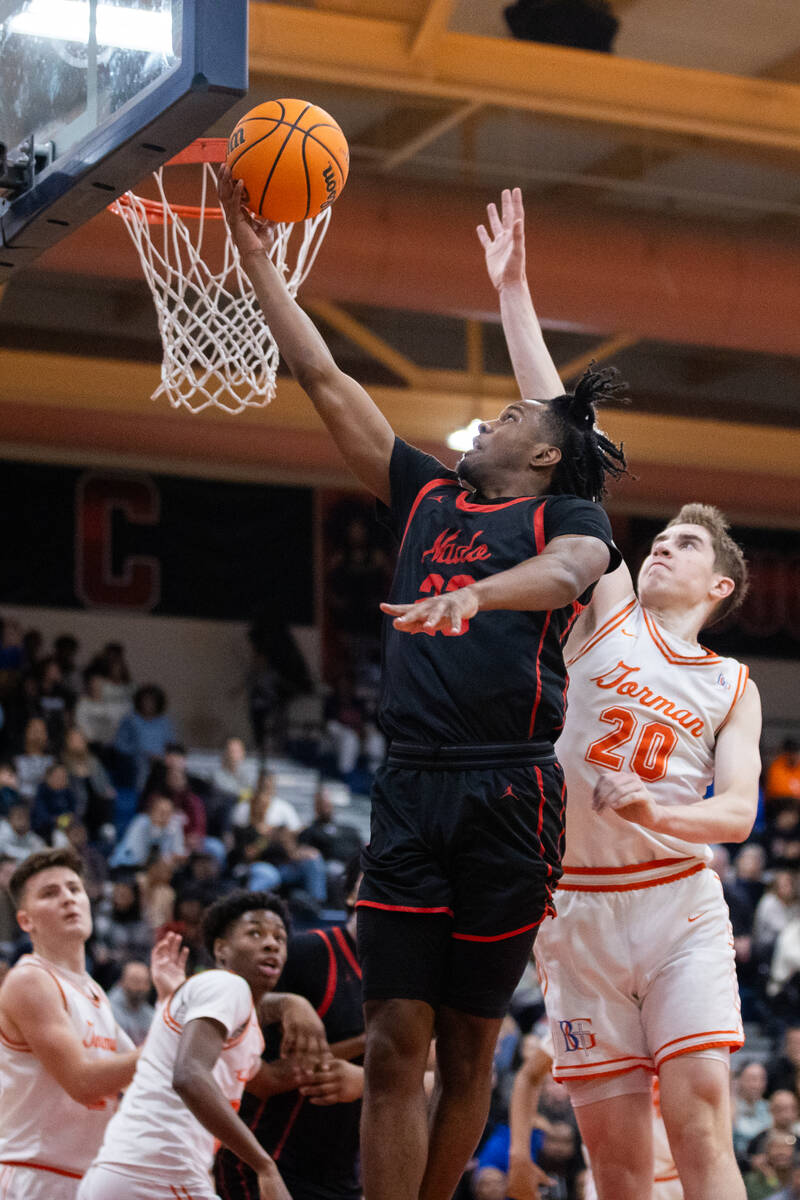 Coronado’s Josiah Cunningham (23) shoots a layup around Bishop Gorman’s Ilan Niko ...